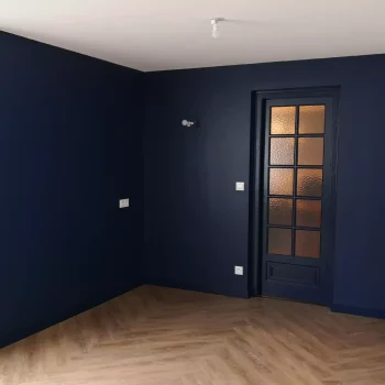 Pièce peinte en bleu marine avec parquet à chevrons